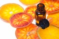 Orange essential oil in amber bottle with red oranges Royalty Free Stock Photo