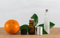 Orange Essential Oil Bottle With Black Cap, Citrus Leaves and Roller Bottle Royalty Free Stock Photo