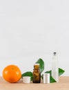 Orange Essential Oil Bottle With White Cap, Citrus Leaves and Roller Bottle Royalty Free Stock Photo