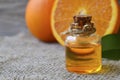 Orange essential oil in a glass bottle for skin care, spa, wellness, massage, aromatherapy and natural medicine. Royalty Free Stock Photo