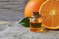 Orange essential oil in a glass bottle for skin care, spa, wellness, massage, aromatherapy and natural medicine. Royalty Free Stock Photo