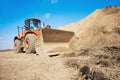 Orange excavator on a construction site Royalty Free Stock Photo