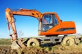 Orange excavator on a platform