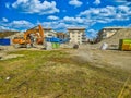 Orange excavator on the site of bilding, dismantling of the building Royalty Free Stock Photo