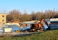 Orange excavator working on an industrial building site Royalty Free Stock Photo