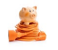 Orange extension power cord and piggy bank isolated on white background Royalty Free Stock Photo