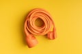 Orange extension Power Cord on yellow background Royalty Free Stock Photo