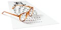 Orange eyeglasses on visual test chart isolated on white. Royalty Free Stock Photo