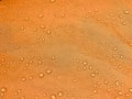 Orange fabric texture with water drops. Waterproof fabric Royalty Free Stock Photo