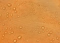 Orange fabric texture with water drops. Waterproof fabric Royalty Free Stock Photo