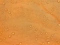 Orange fabric texture with water drops. Waterproof fabric Royalty Free Stock Photo