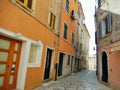 ORANGE FACADES IN A COBBLESTONE STREET IN POREC, CROATIA