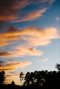 Orange fall clouds against a blue sky.