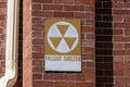 Orange Fallout Shelter sign on a brick wall. With global instability, Fallout Shelters may become more popular