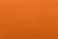 Orange faux leather with large embossing. Texture for background and design.