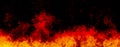 Orange fire or flames with sparkles and smoke in black background. Royalty Free Stock Photo