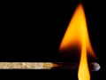 Orange fire of a wooden match isolated on a black Royalty Free Stock Photo