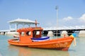 Orange fishing boat on a pebble beach Royalty Free Stock Photo