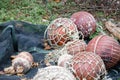 Orange fishing buoys wrapped in fishing nets