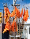 Orange flags marking fishing nets on board a fishing boat in the harbor of Hanstholm, Denmark Royalty Free Stock Photo