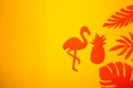 orange flamingo jumps pineapple in jungle leaves orange color on a yellow background, creative art summer design