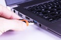 Orange flash disk with laptop USB slot Royalty Free Stock Photo