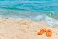 Orange flip flops or slippers on the beach Royalty Free Stock Photo