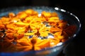 Orange flower float on water in glass bowl. Royalty Free Stock Photo