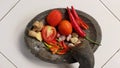 Several types of ingredients on a mortar that is ready to be mashed into chili sauce. Royalty Free Stock Photo