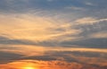 Orange fluffy sunset clouds over blue sky Royalty Free Stock Photo