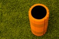 Orange foam roller on green background Royalty Free Stock Photo