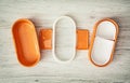 Orange folding plastic food box on the wooden background