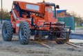 Large orange fork lift on a construction site