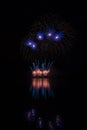 Orange fountain and blue stars fireworks over Brno`s Dam with lake reflection Royalty Free Stock Photo