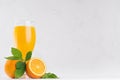 Orange fresh citrus juice with ripe oranges and green leaf on soft white wood board, copy space. Royalty Free Stock Photo