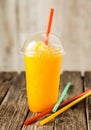 Orange Frozen Slushie in Plastic Cup with Straw Royalty Free Stock Photo