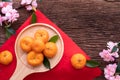 Orange fruit and cherry blossom on wood table, Chinese new year celebration background Royalty Free Stock Photo