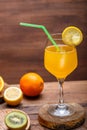 Orange fruit cocktail with a straw garnished with a slice of lemon in a large glass Royalty Free Stock Photo