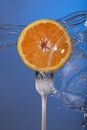 Orange fruit fork water splash blue concept health Royalty Free Stock Photo