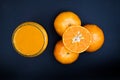 Orange fruit and fresh orange juice on black background Royalty Free Stock Photo