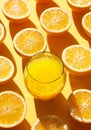 Orange fruit and glass orange juice on a orange back Royalty Free Stock Photo