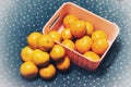Orange fruit with green leaves on the white wood. Home gardening. Mandarine oranges. Tangerine oranges. Orange color. Fresh orange