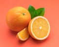 Orange fruit with orange slices and leaves isolated on orange background Royalty Free Stock Photo