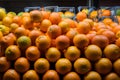 Orange fruit pile on stall in supermarket, market display Royalty Free Stock Photo