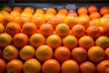 Orange fruit pile on stall in supermarket, market display Royalty Free Stock Photo