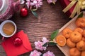 Orange fruit, pink cherry blossom and Chinese new year composition set on wood table, Chinese new year celebration background Royalty Free Stock Photo