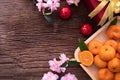 Orange fruit, pink cherry blossom and Chinese new year composition set on wood table, Chinese new year celebration background Royalty Free Stock Photo