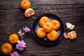 Orange fruit and pink cherry blossom on wood table. concept of celebration Chinese new year festival background Royalty Free Stock Photo