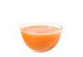 Orange fruit sauce in a glass bowl close-up on a white background Royalty Free Stock Photo
