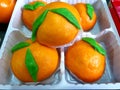 Orange fruit-shaped sweet buns in the package.